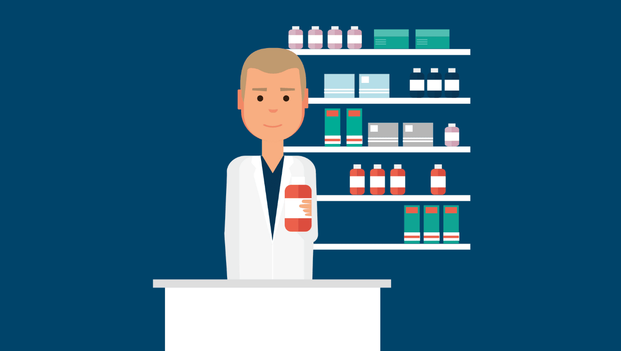 pharmacist holding prescription in pharmacy